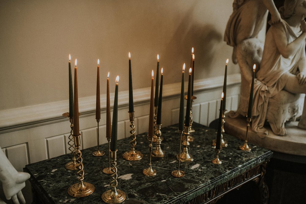 Black wedding theme candles in gold candlesticks 