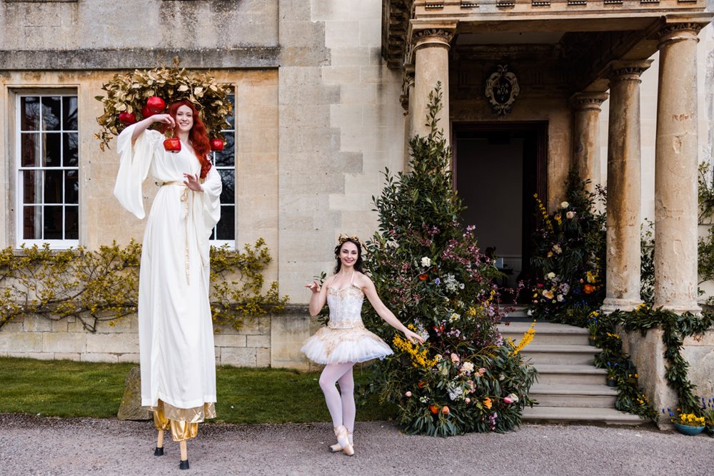 Unusual wedding venue open day with festival walkabout performers on stilts and a ballet dancer