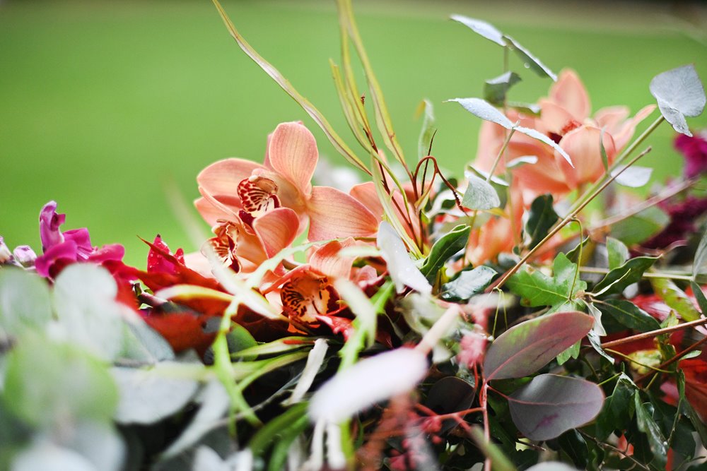 Bright autumn wedding flowers close up details for a fun halloween themed hocus pocus wedding in the cotswolds