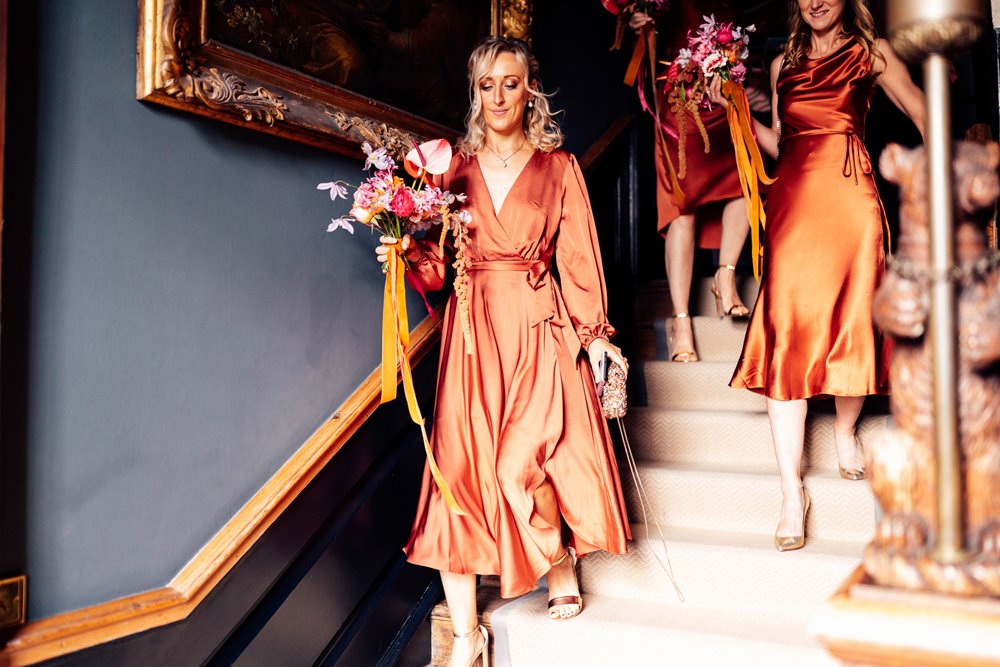 burnt orange bridemaids dresses in mansion house wedding venue