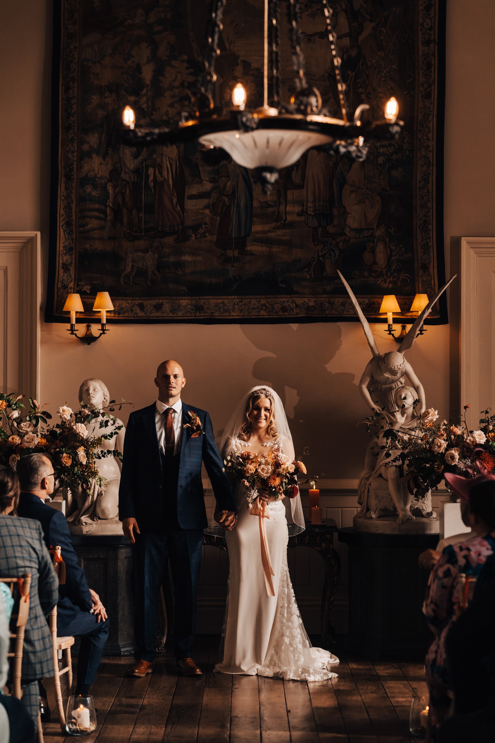 Bride and groom at beautiful autumnal wedding ceremony in a manor house in gloucestershire