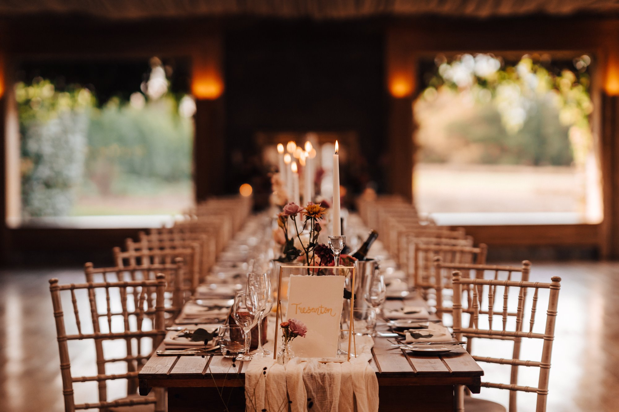 elegant wedding reception table, lit with candles in the gillyflower at Elmore Court