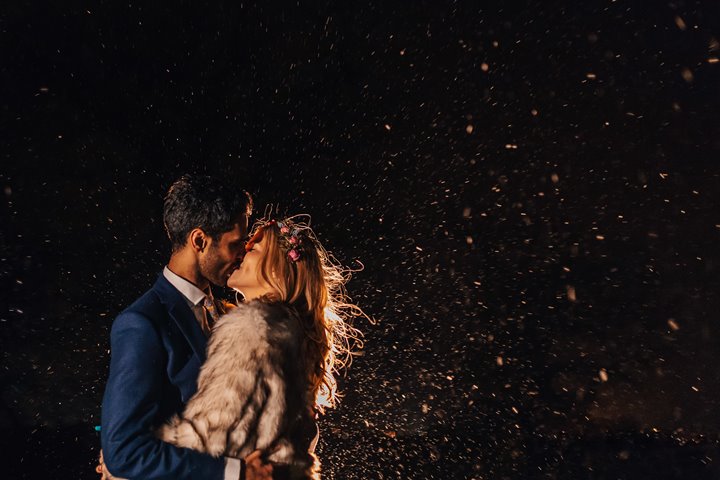 Newlywed couple kiss under star flecked night sky at a romantic boho winter wedding at Elmore Court in Gloucester