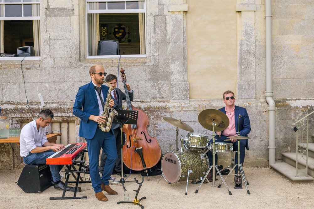 Jazz band playing outside elmore court for a gay wedding party