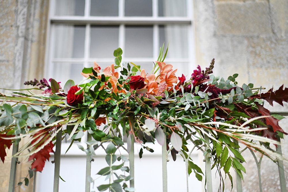 Bright autumn wedding flowers decorating the outside of mansion house wedding venue in October