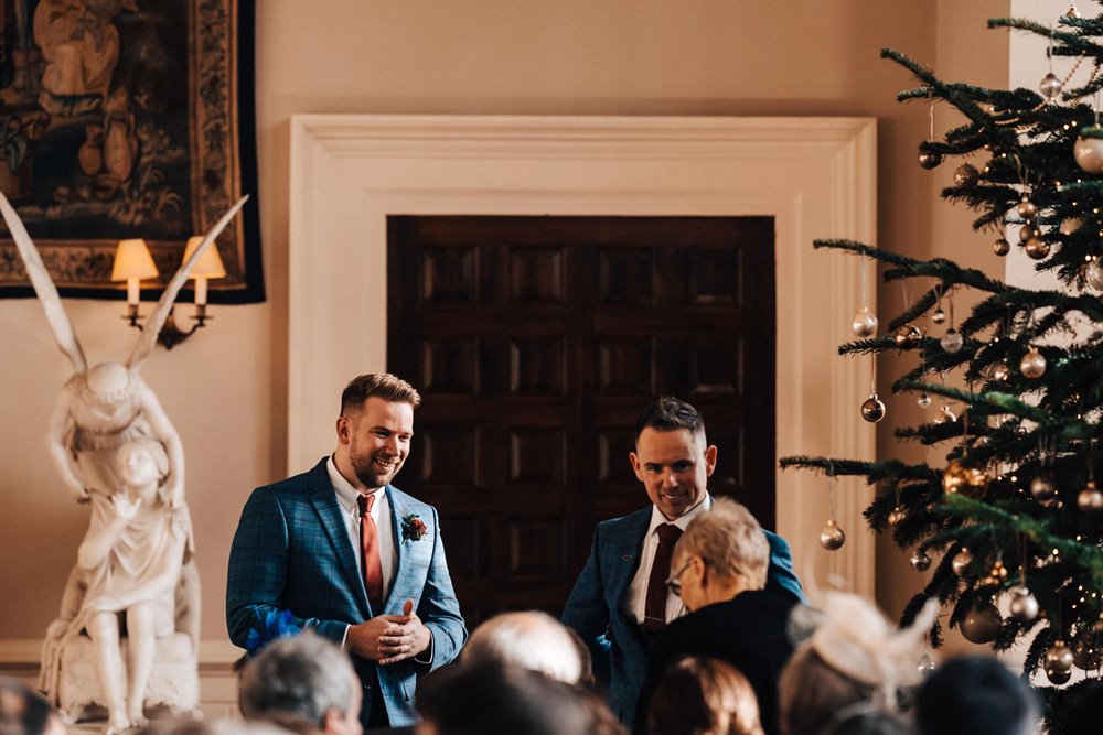 christmas wedding venue with groomsmen waiting for ceremony to start