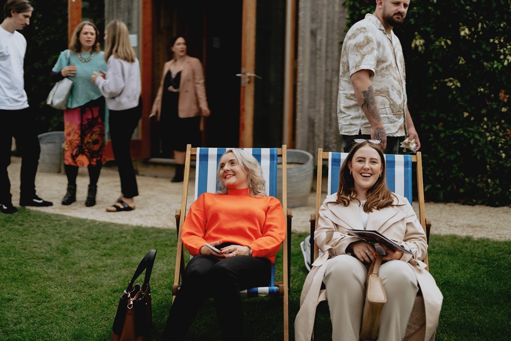 Wedding fair guests relaxing in deckchairs by every event hire