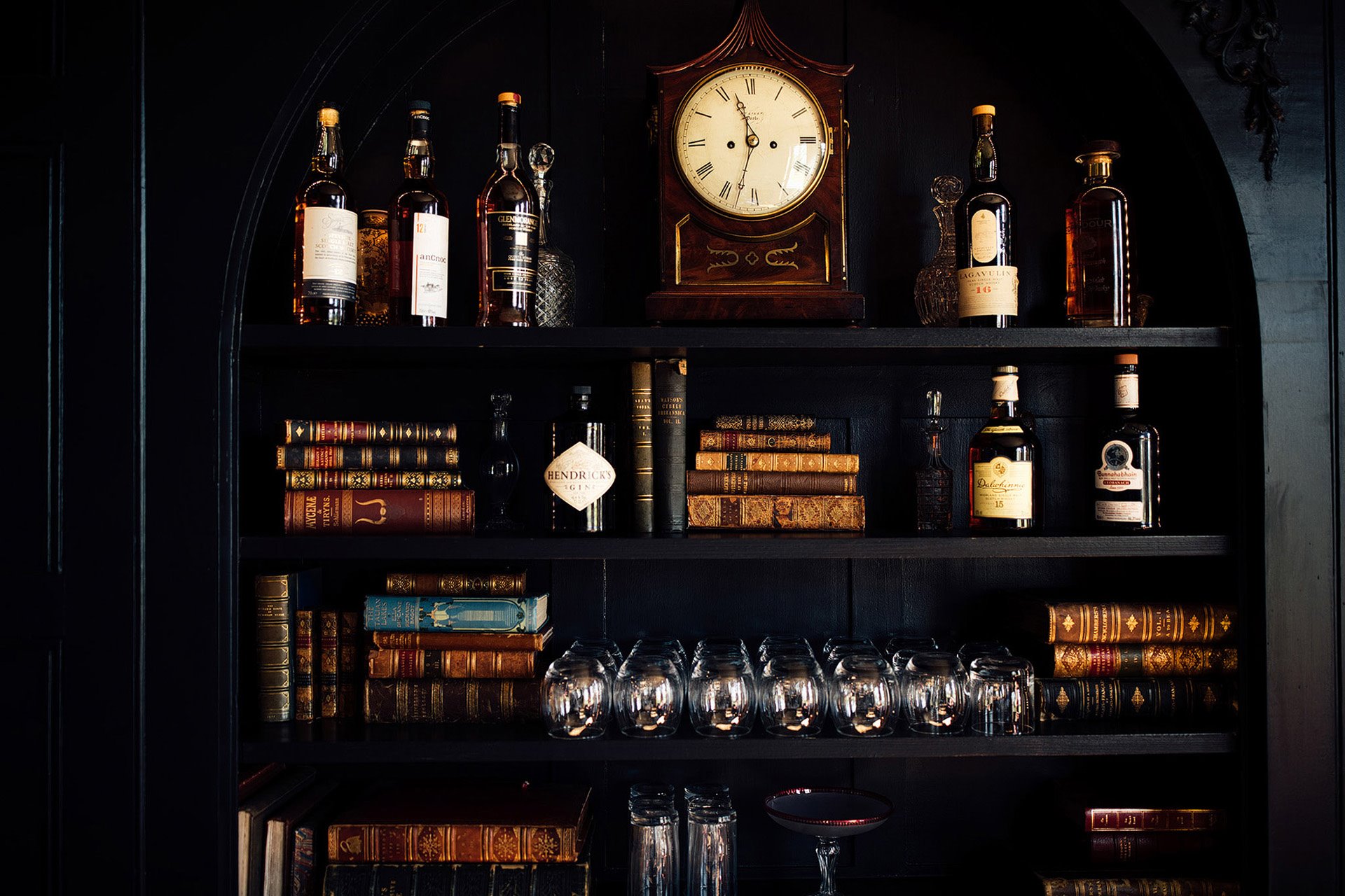 Bookshelf full of antiques and old books in an old mansion house in the cotswolds, makes a very unusual place to stay