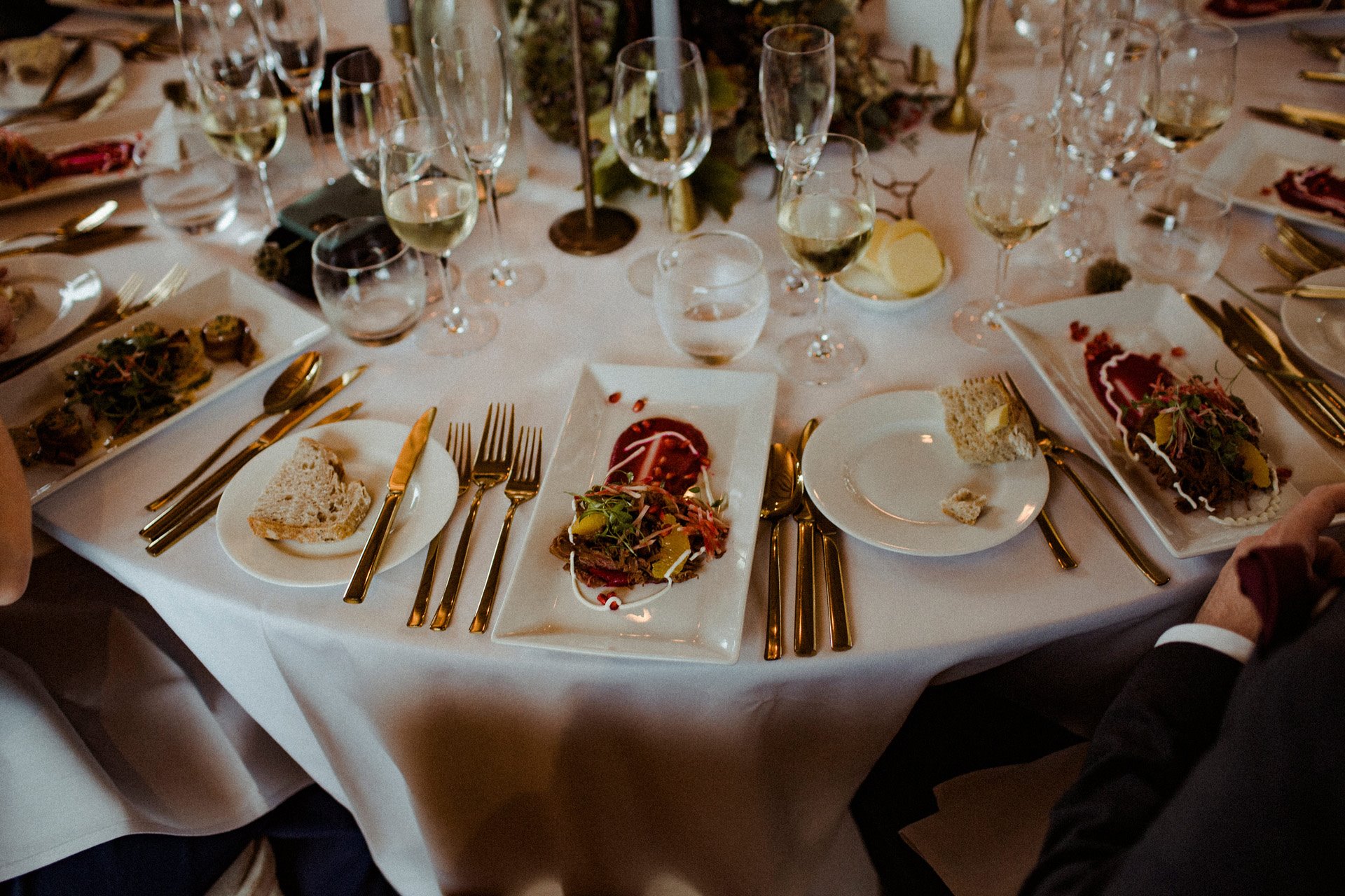 Autumnal wedding food on a round table with gold cutlery. Food at Elmore Court rated 5 stars by guests