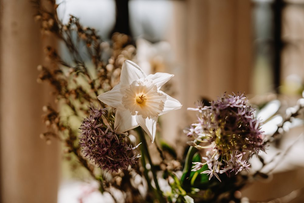 rustic wedding flowers on a table display at a wedding ceremony in gloucestershire