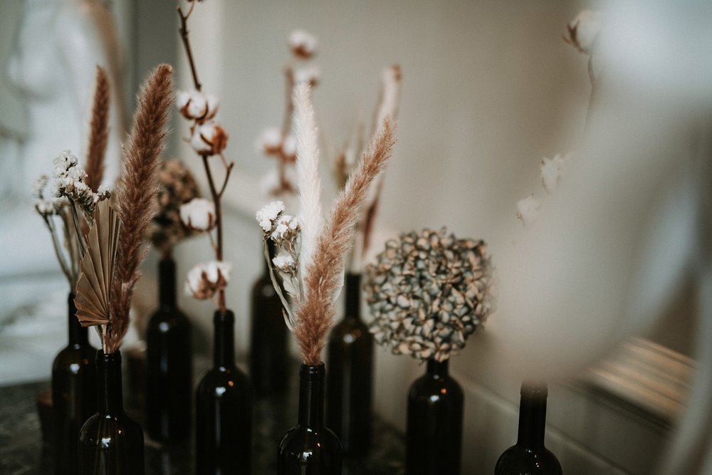 Black wedding theme dried flowers in dark bottles