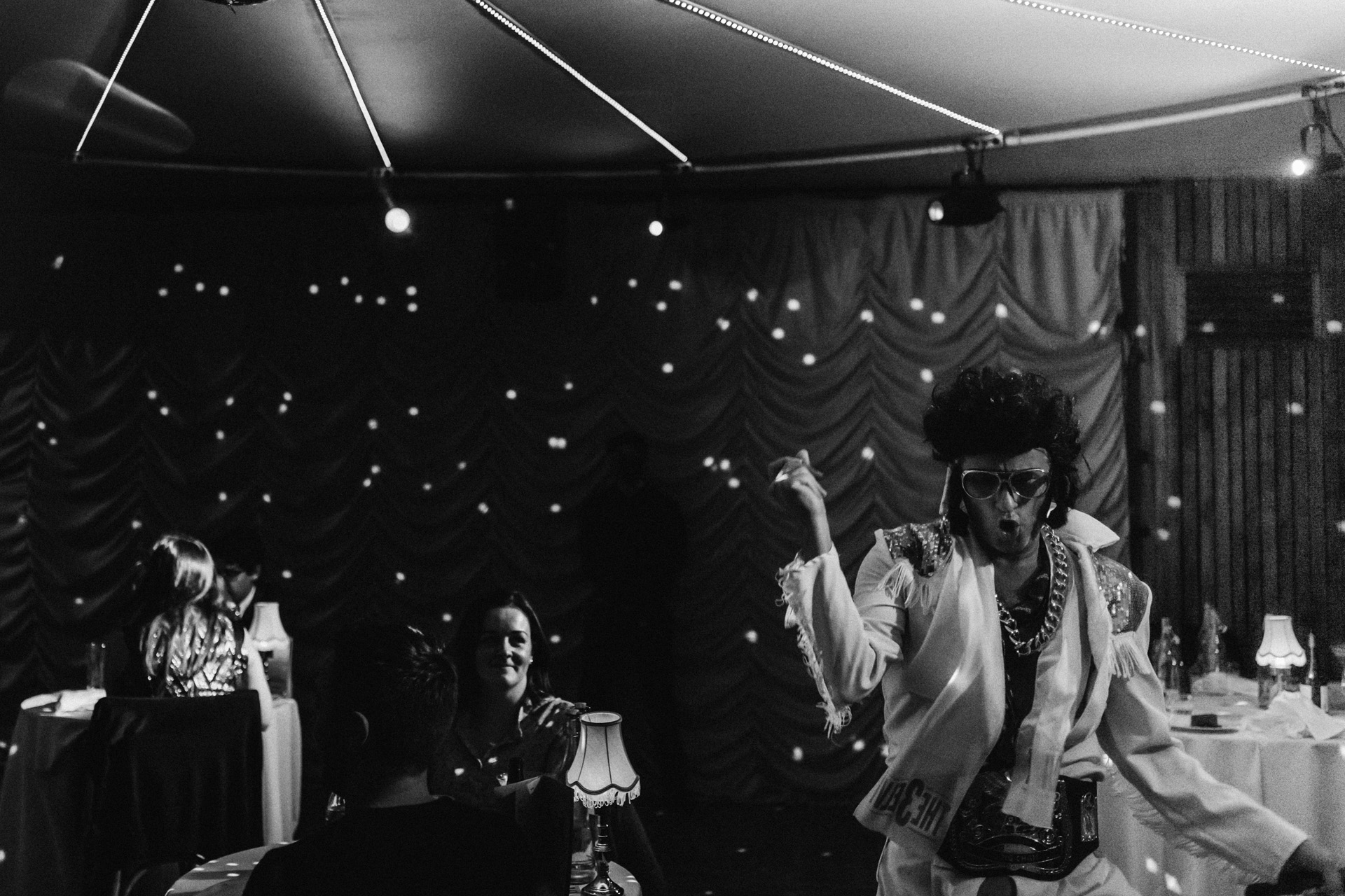 Elvis impersonator walks around the audience at cabaret show