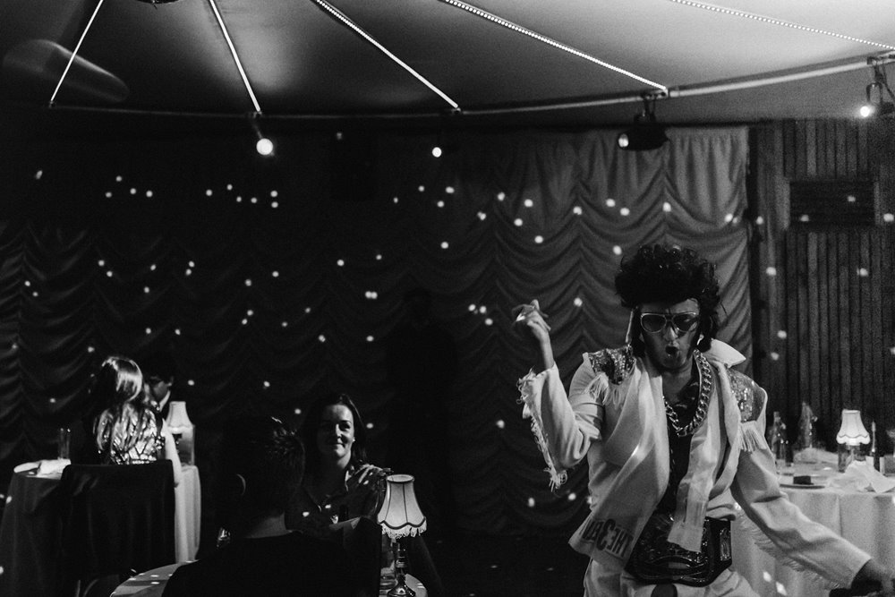 Elvis impersonator walks around the audience at cabaret show