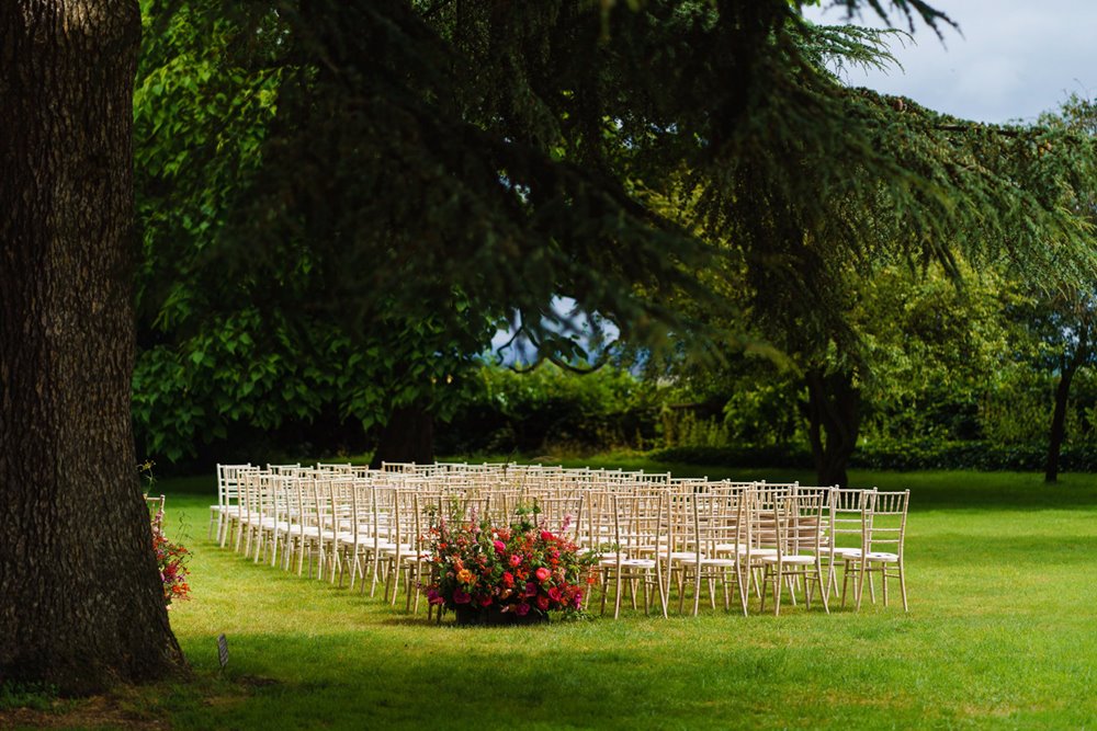 Outdoor wedding ceremony on the lawn in summer at wedding venue elmore court