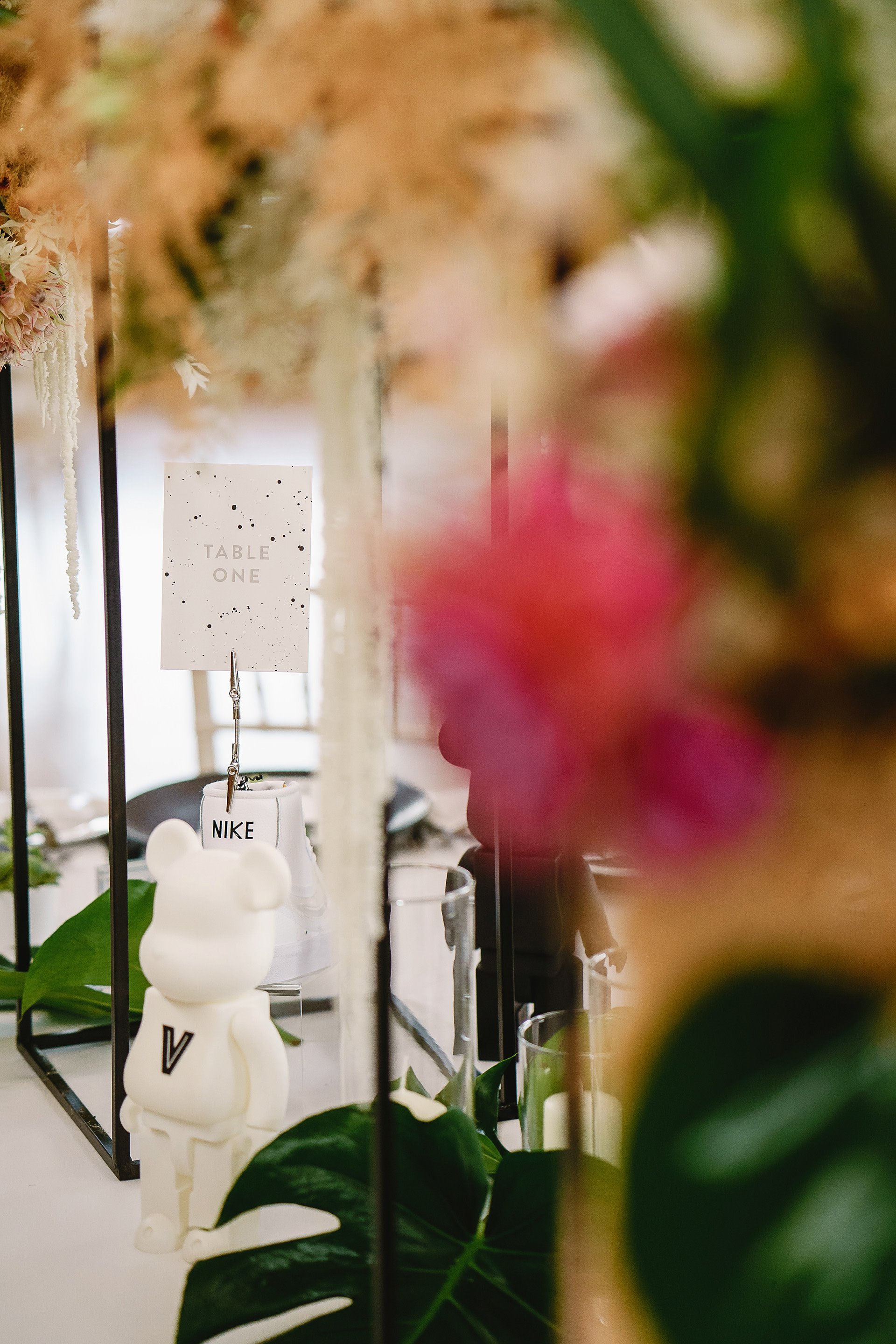 DIY wedding details on tables at lesbian wedding reception in the cotswolds