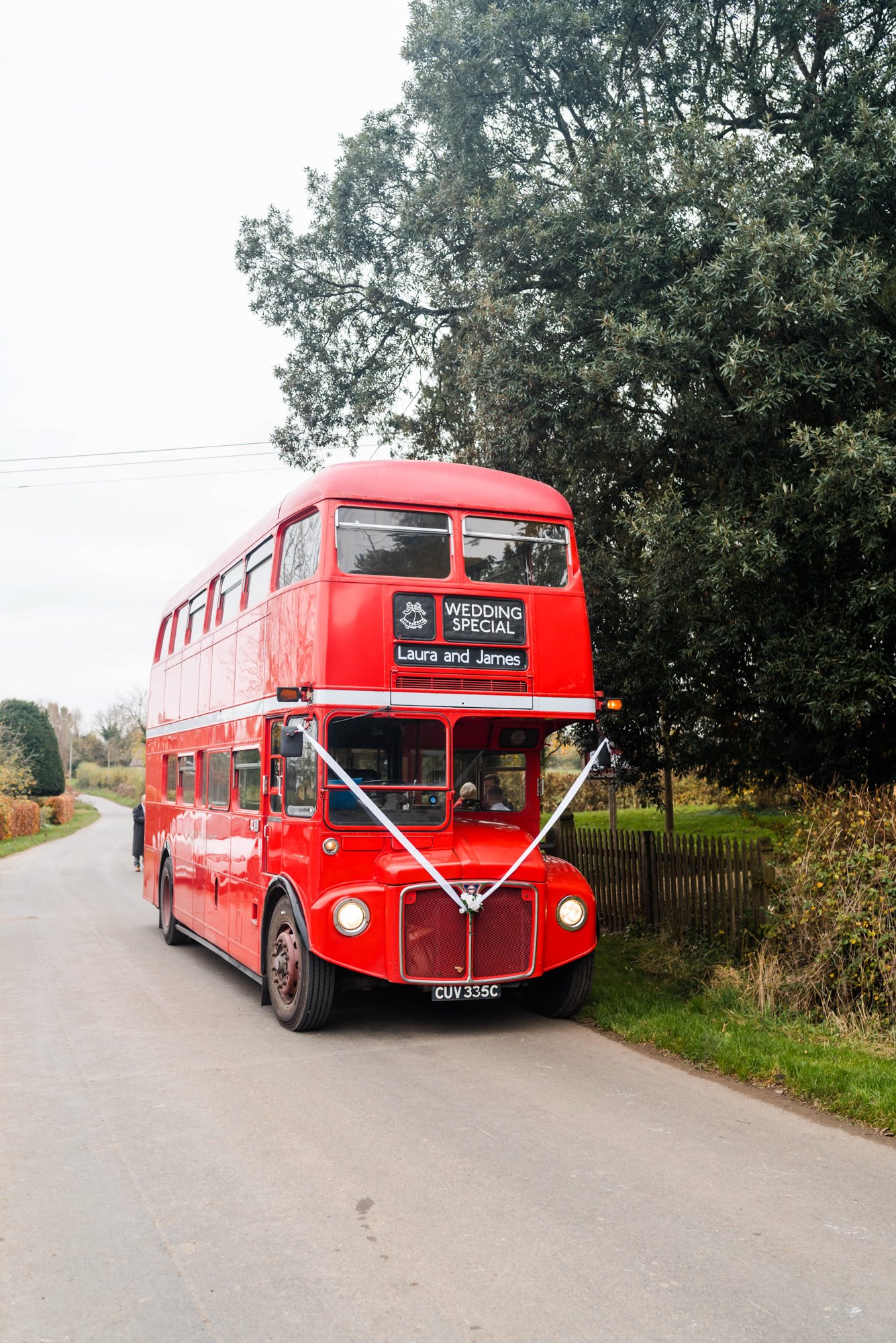 big red london bus for a vintage wedding garden party