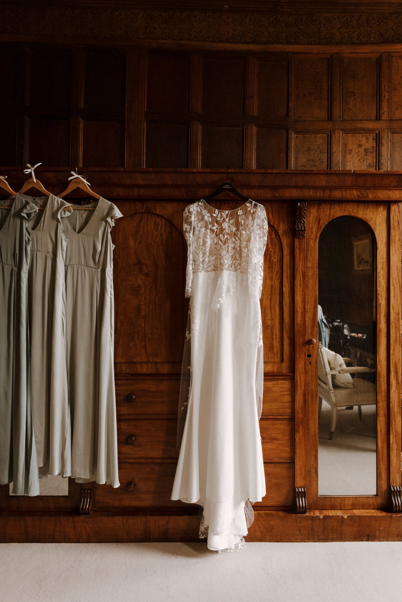 beautiful boho lace dress hanging in gorgeous wood panelled room in stately home