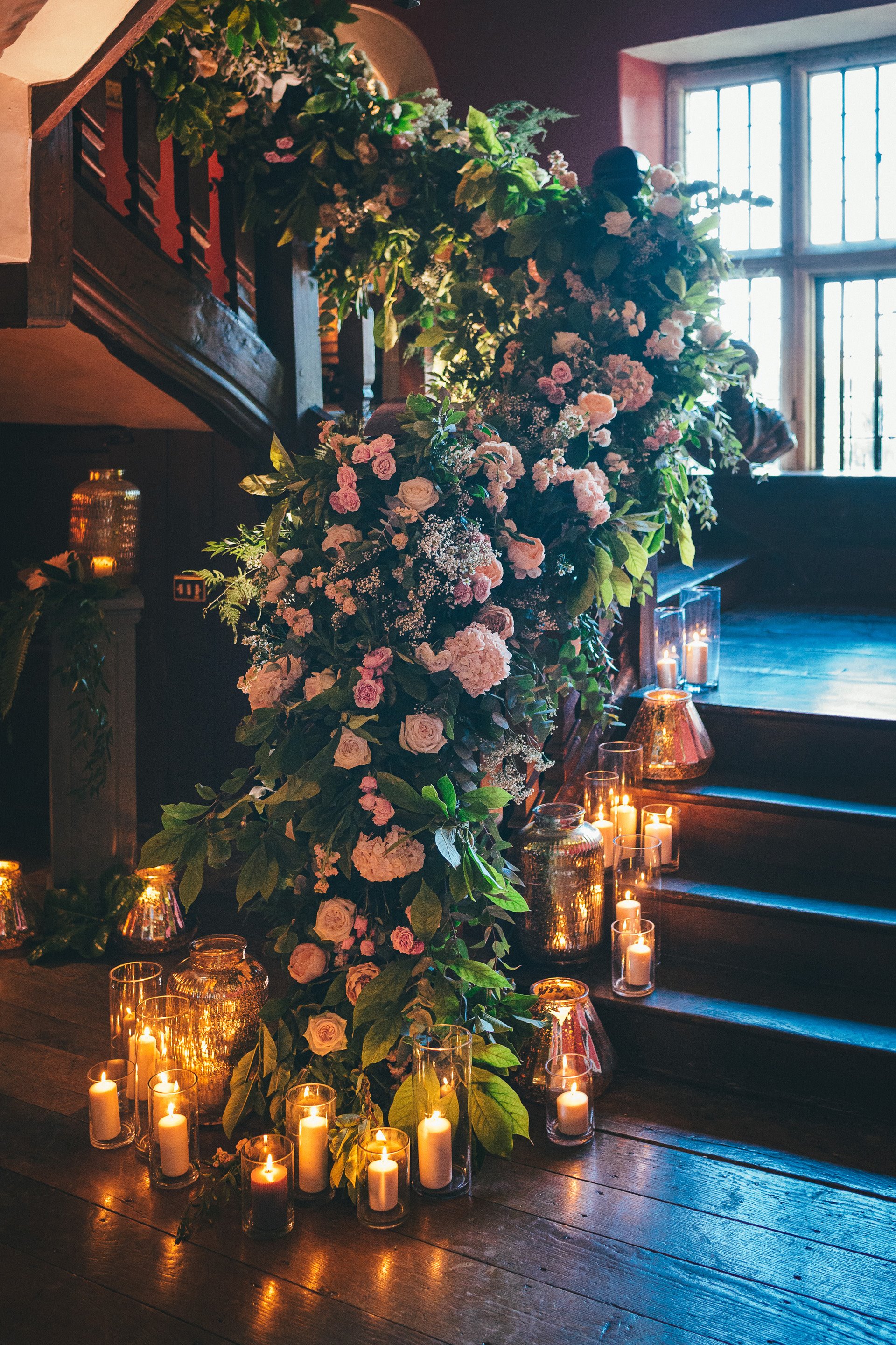 Floral staircase with candles as a micro wedding with big style idea at elmore court