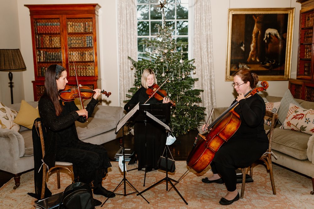 A string quartet playing beautiful music at a Christmas wedding drinks reception at Elmore Court