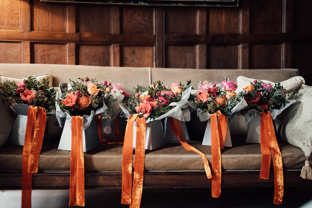 Beautiful bright bridal bouquets with orange ribbons ready for wedding
