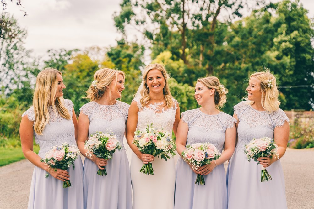Pastel colour wedding inspiration. Bridesmaids in pale blue with neutral bouquets