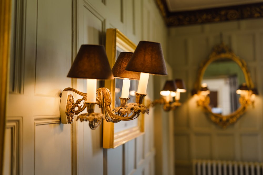 Historic house wedding venue details lamps on wall in drawing room