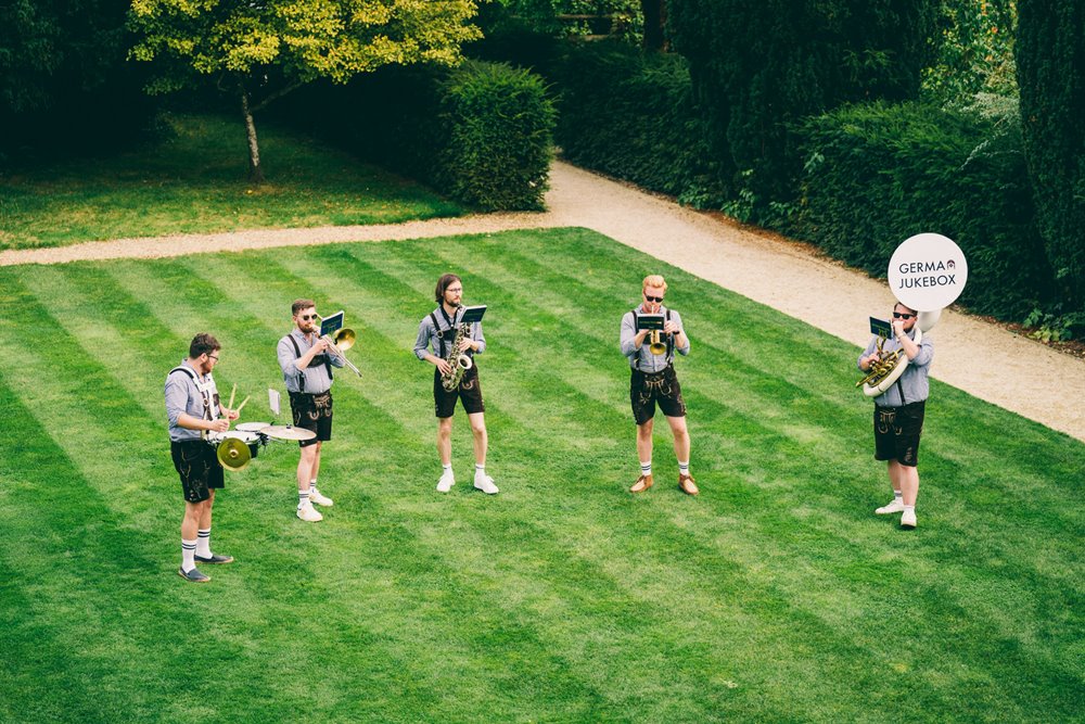 Festival wedding band playing on the lawn at wild wedding venue in Gloucestershire