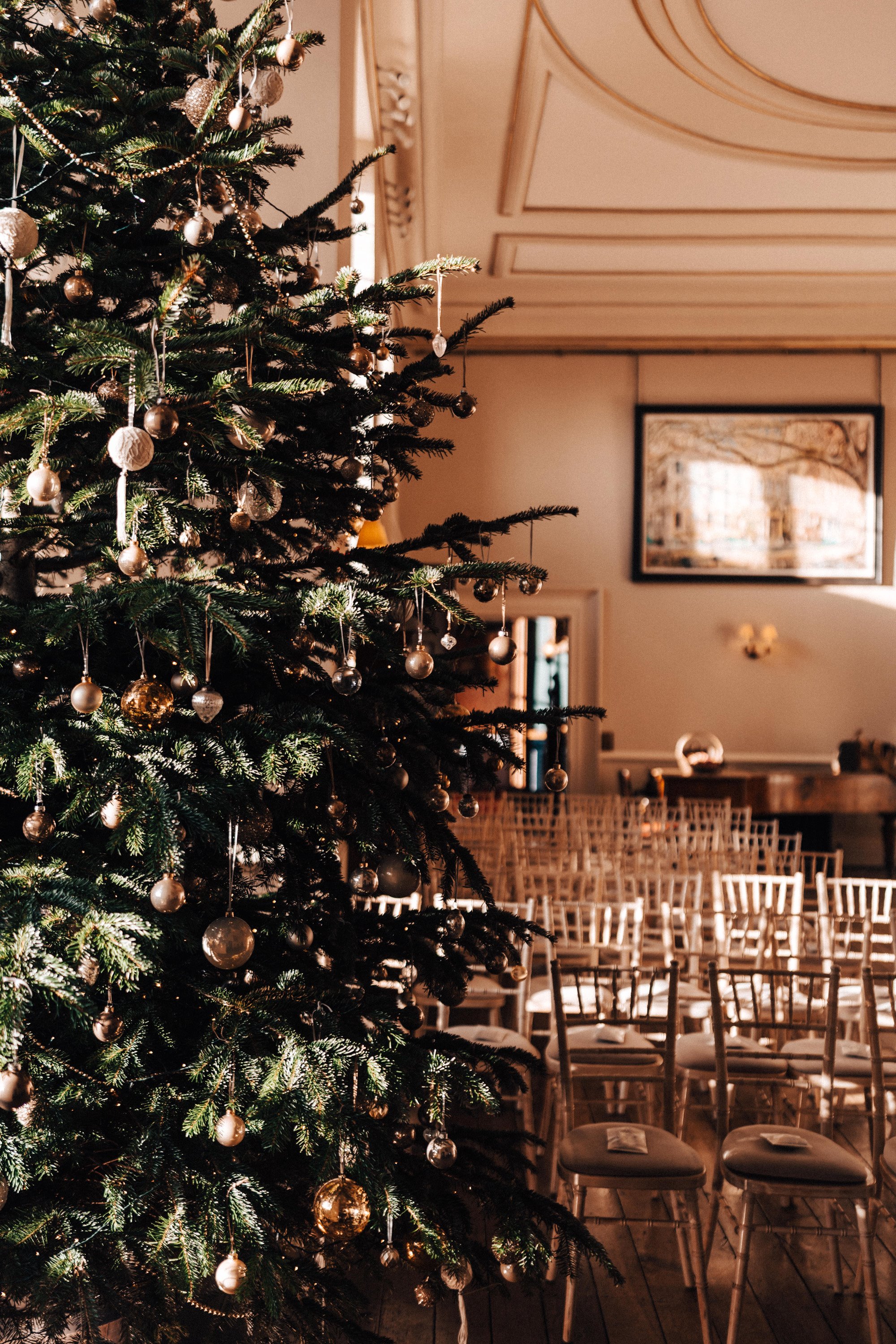 Huge Christmas tree in a beautiful stately home winter wedding venue in the Cotswolds