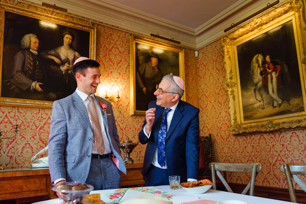 Jewish groom in grey suit and pink kippot