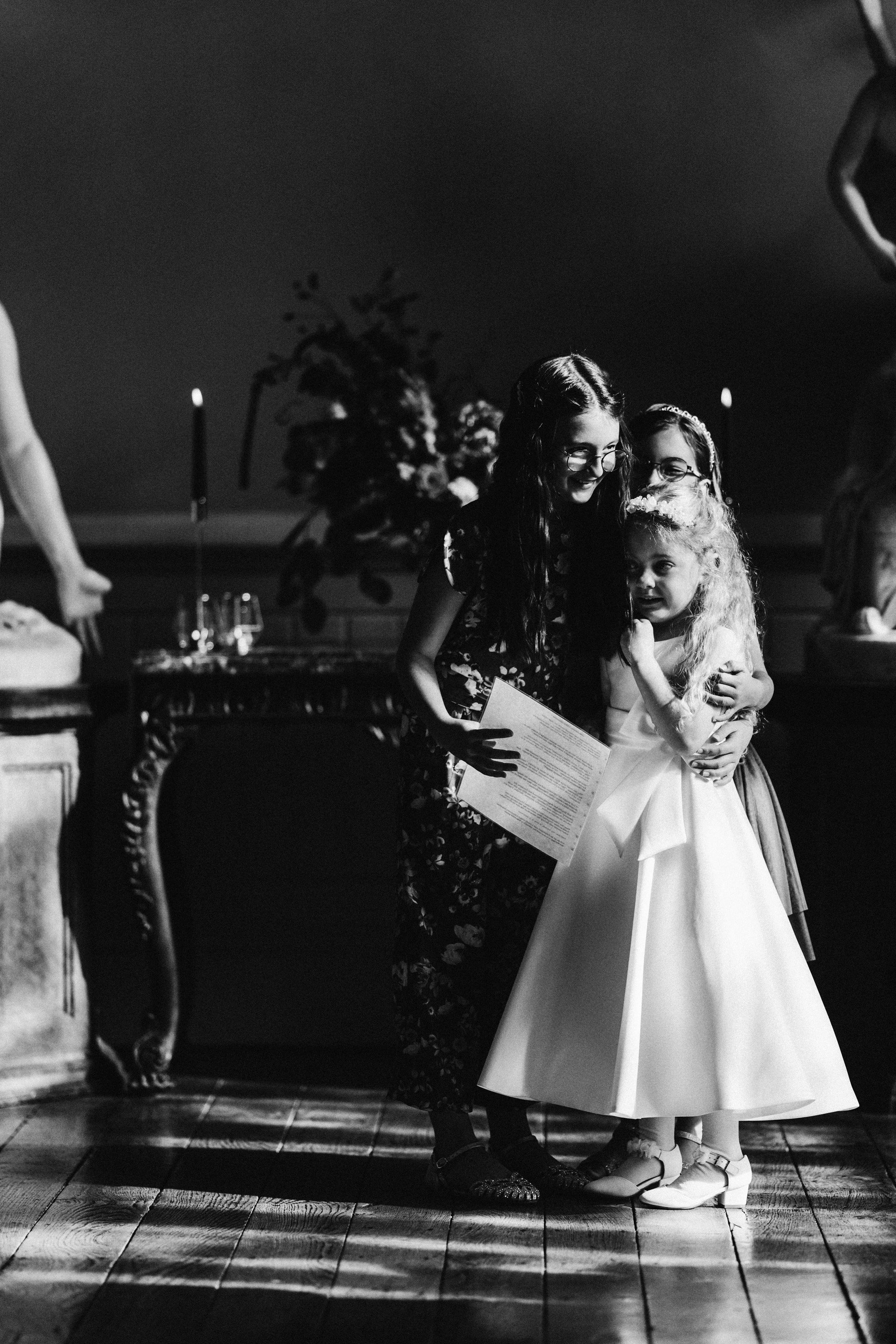 Children taking part in wedding ceremony readings at a moody october wedding in a big country house in gloucestershire