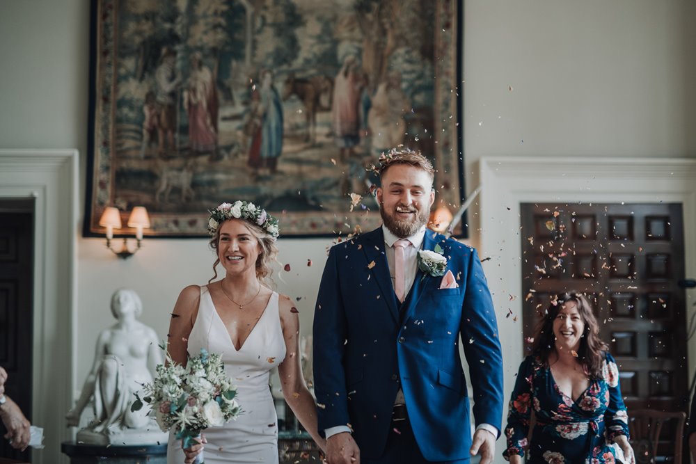 Micro wedding couple just married confetti shot in the hall at elmore court