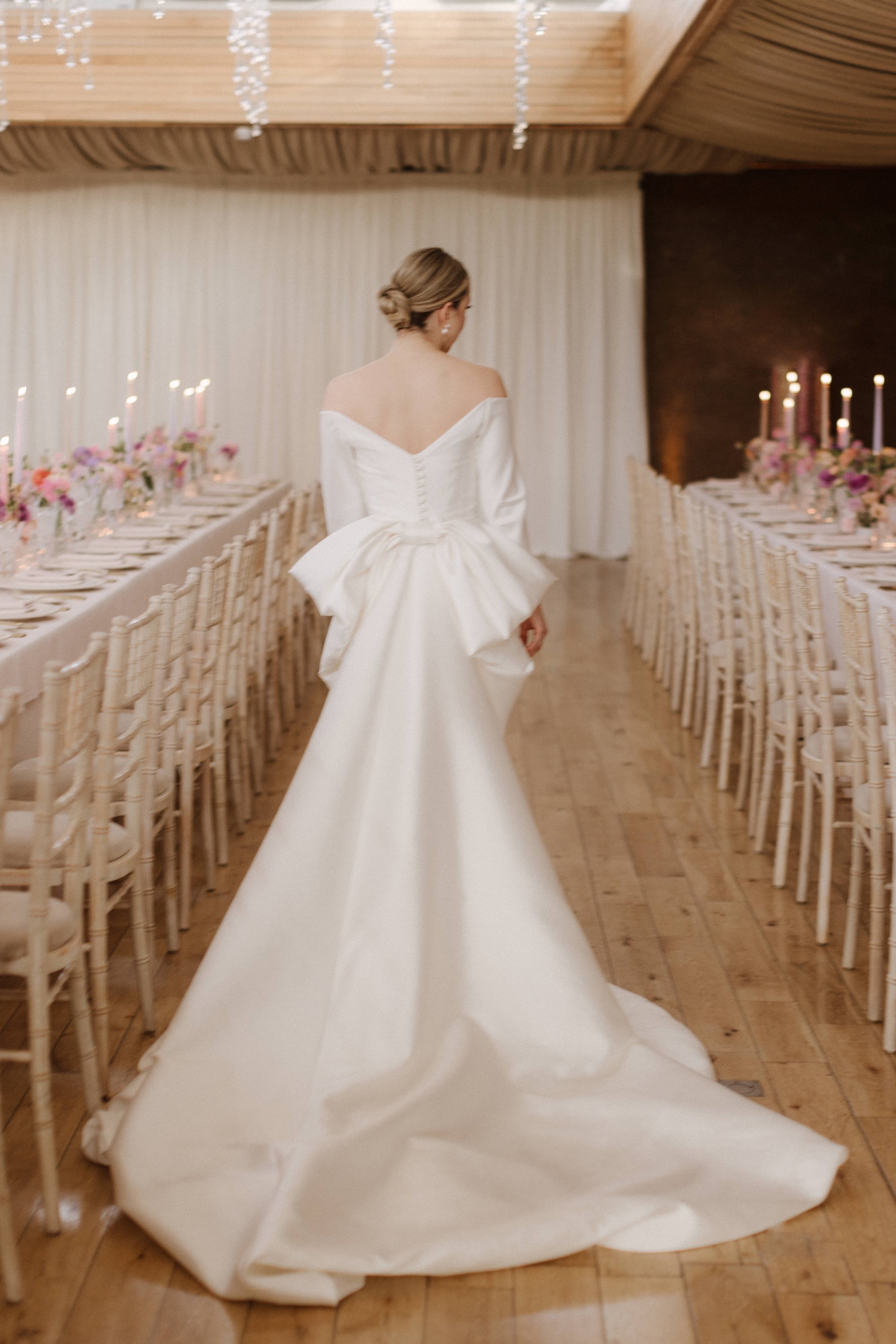 bride in her white wedding dress with na long train