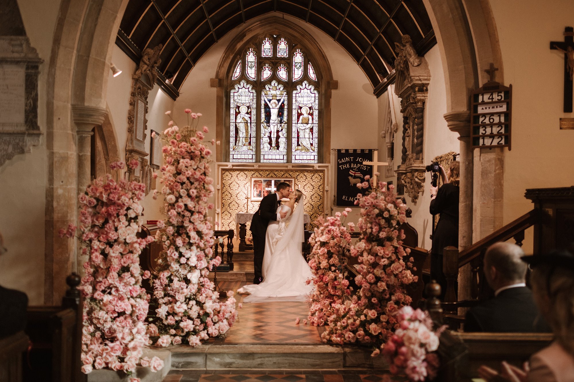 Romantic pink wedding flowers in beautiful towers at a beautiful church wedding in the uk