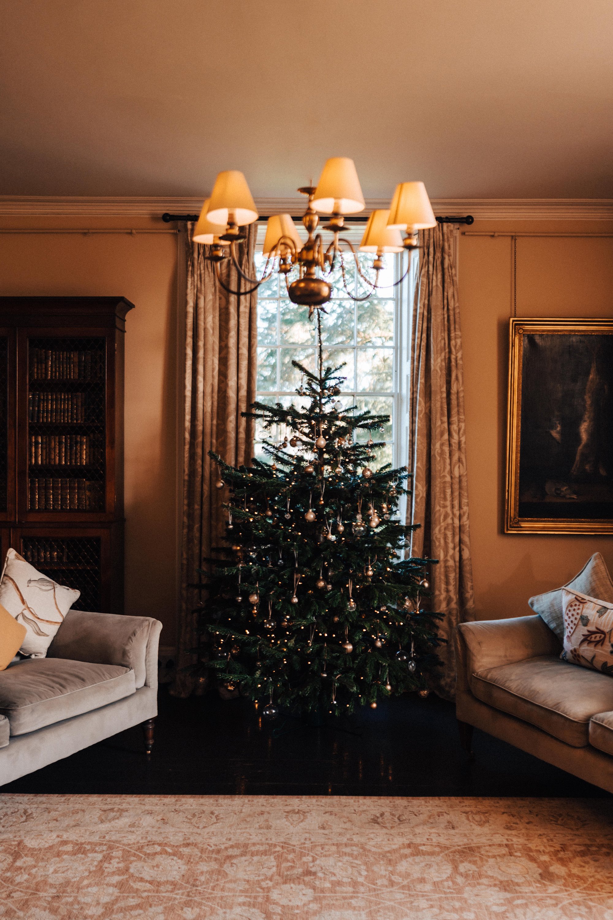 Christmas tree in the morning room of old stately home winter wedding venue elmore court in the cotswolds