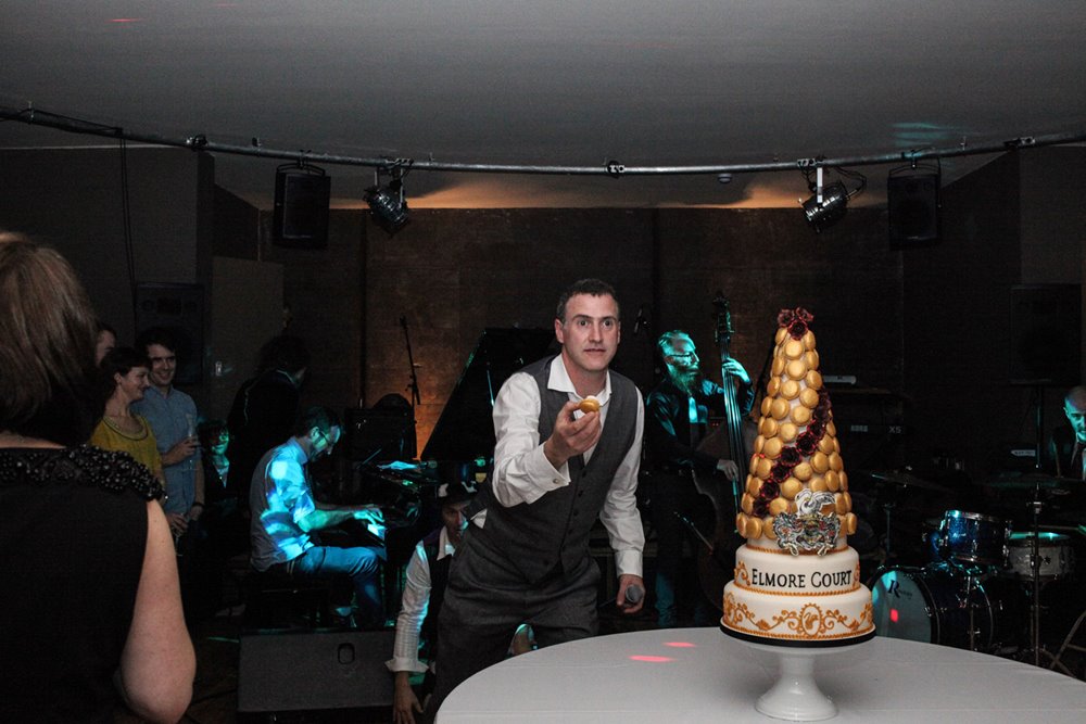 Anselm Guise eats first macaroon off huge cake at massive party for the launch of his wedding venue in 2013