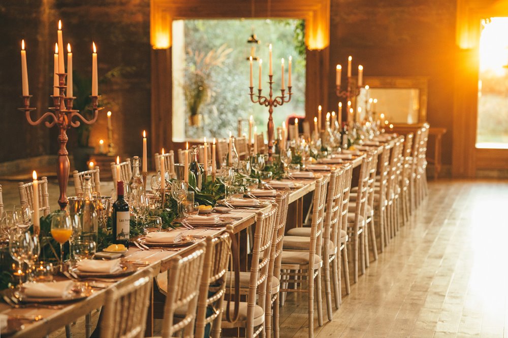 Candlelit Micro wedding reception dinner with banqueting table and candelabras