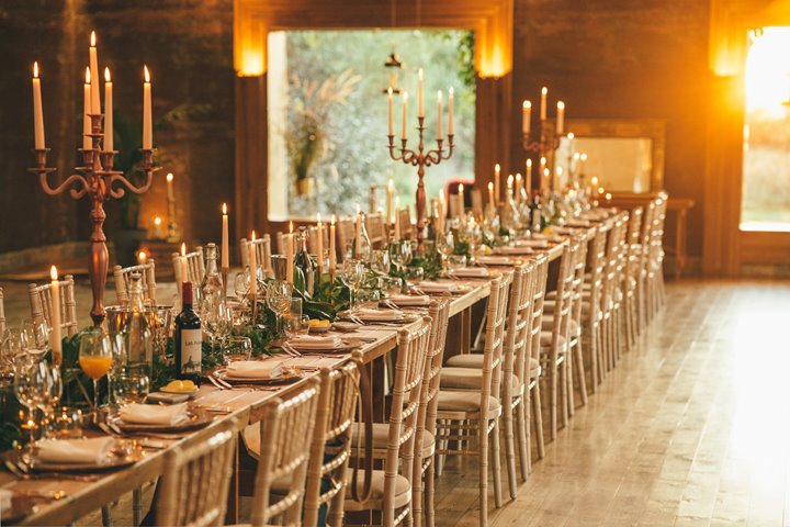 Candlelit Micro wedding reception dinner with banqueting table and candelabras