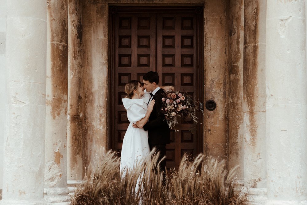 Luxe wedding inspiration at an eco venue with bride in big bows and messy hair and groom in tux