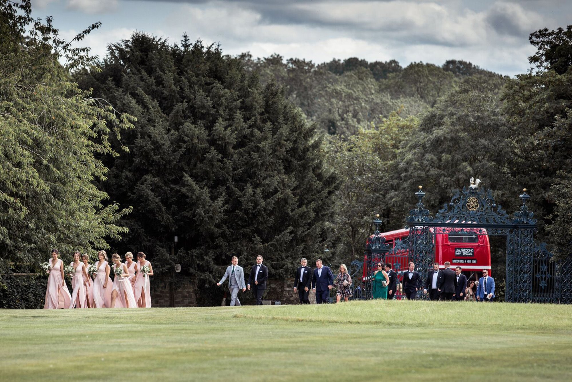 Bridal party get off an Old Double decker bus at the gates of Elmore Court