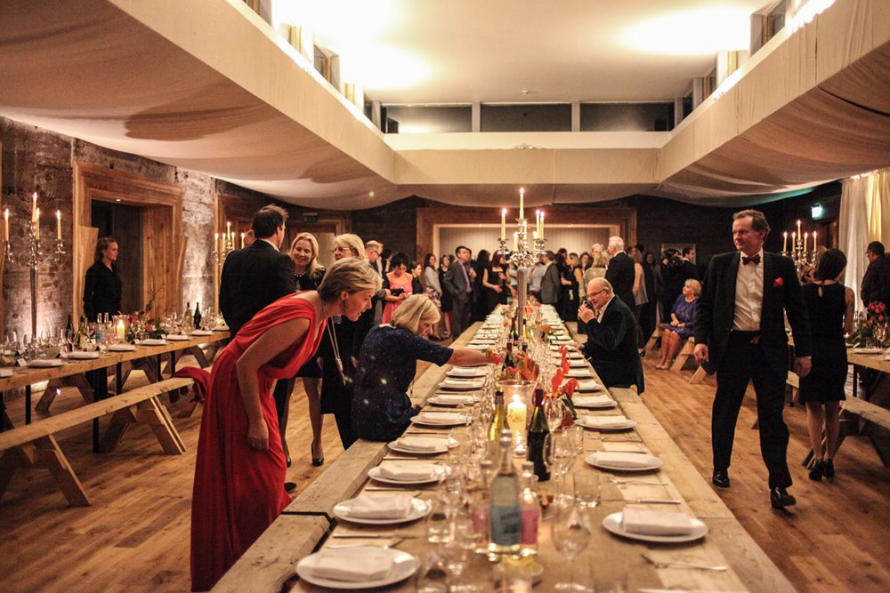 Guests find their seats at beautiful dining tables at the elmore court launch party