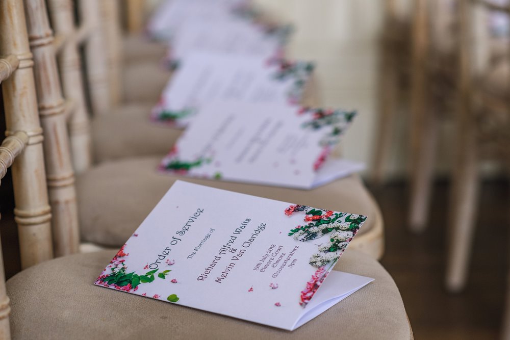 Floral wedding order of the day cards were DIY designed by the grooms