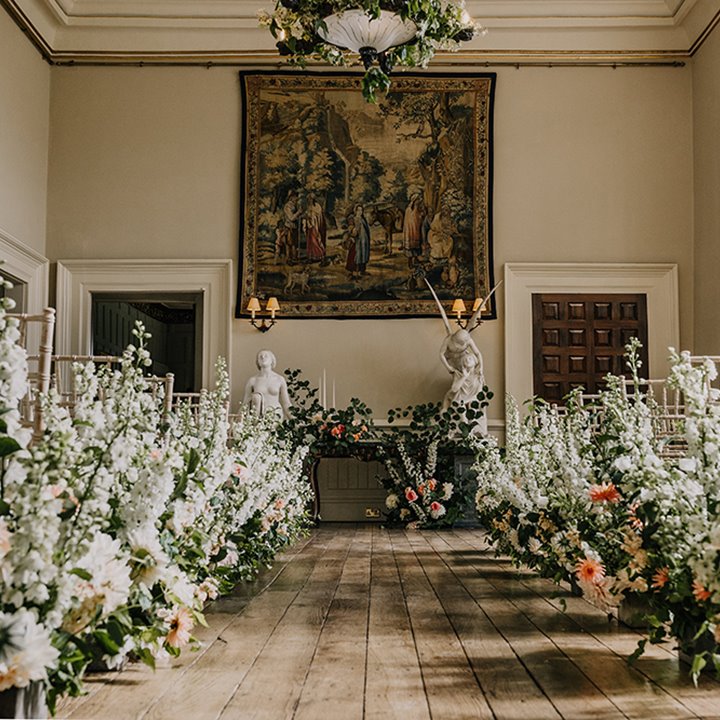 Floral aisle for a luxe botanical wedding at stately home elmore court