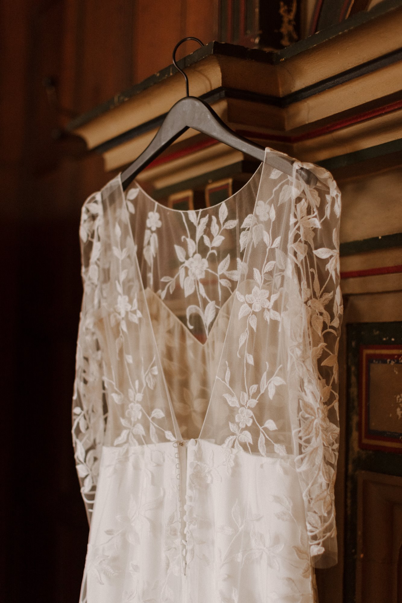 beautiful french lace boho wedding dress hanging up ready to get married in