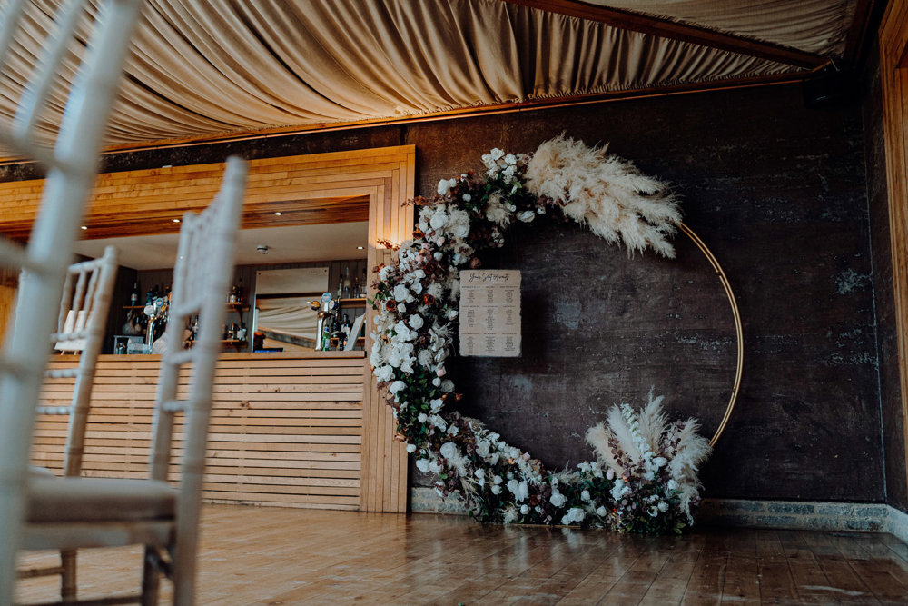 romantic modern wedding arch with pampas grass and roses in a circle