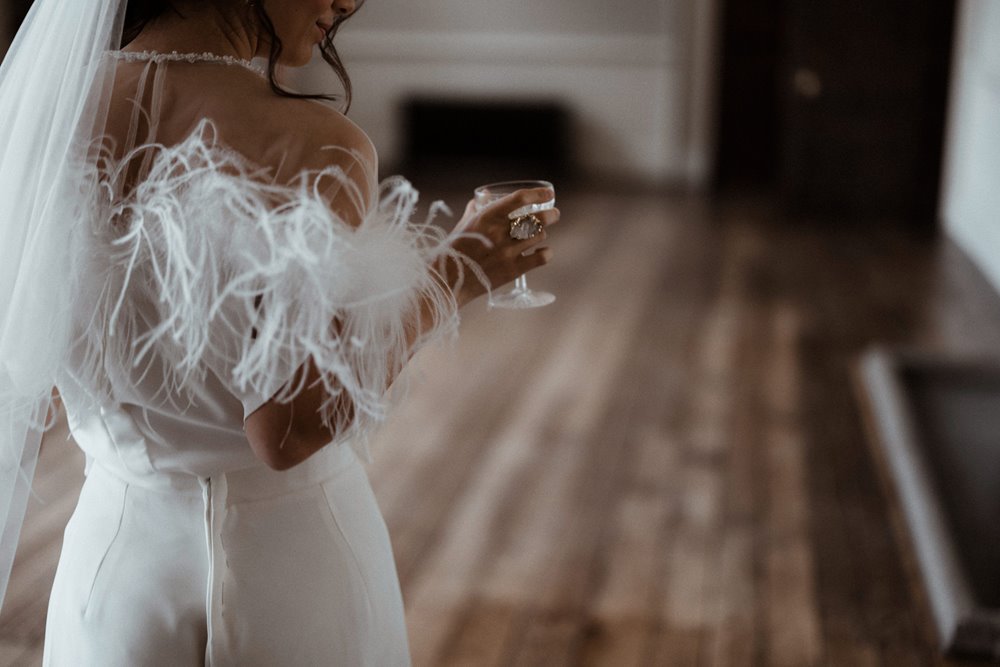 Modern bride in feathers and pearls at elmore court