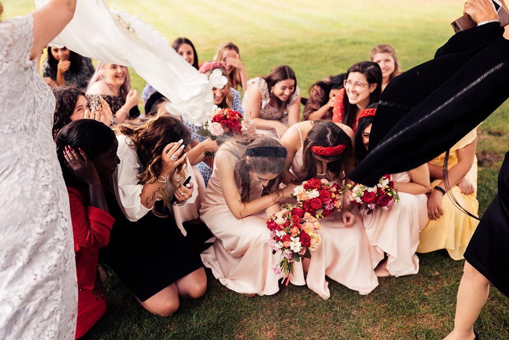 bridesmaids get covered in sugar in funny wedding moment during traditional persian wedding ceremony at elmore court
