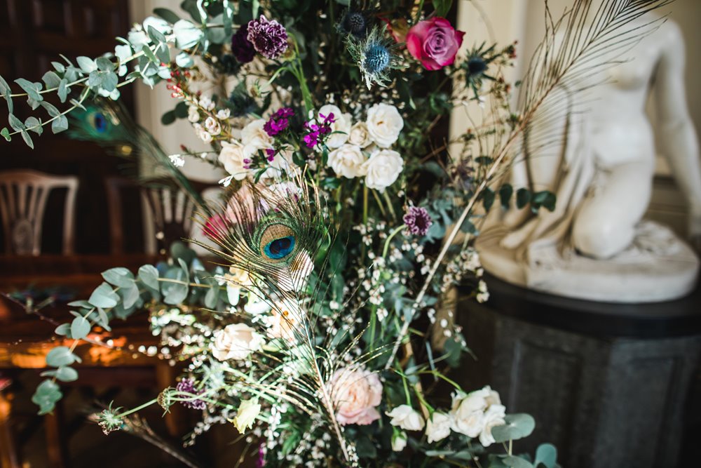 wedding flowers with peacock feathers for a weekend wedding