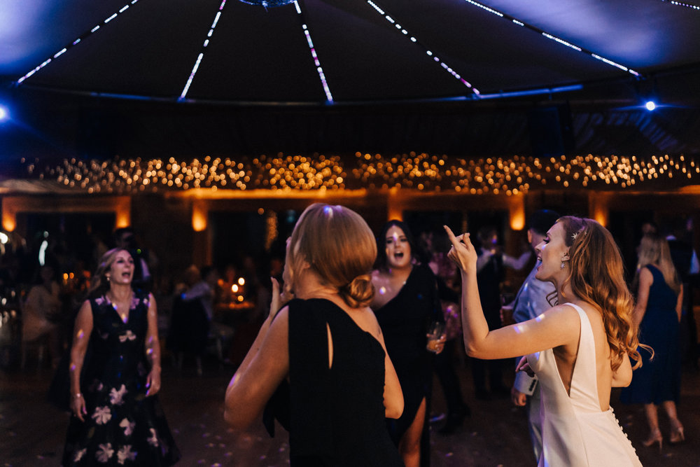 Party wedding with crazy dancing and bridesmaids in black dresses in october in a mansion house with soundproof reception for proper parties