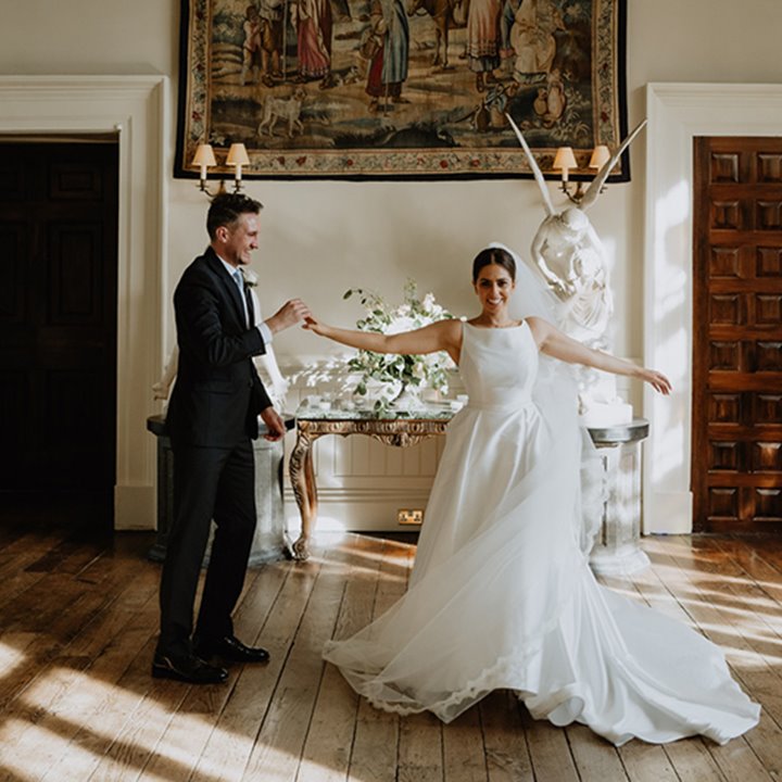 Luxe wedding couple dance alone in the hall at stately home elmore court