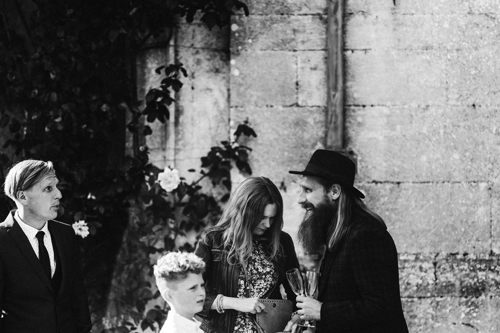 moody photography of hipster wedding guests at a black wedding in a mansion house in the english countryside